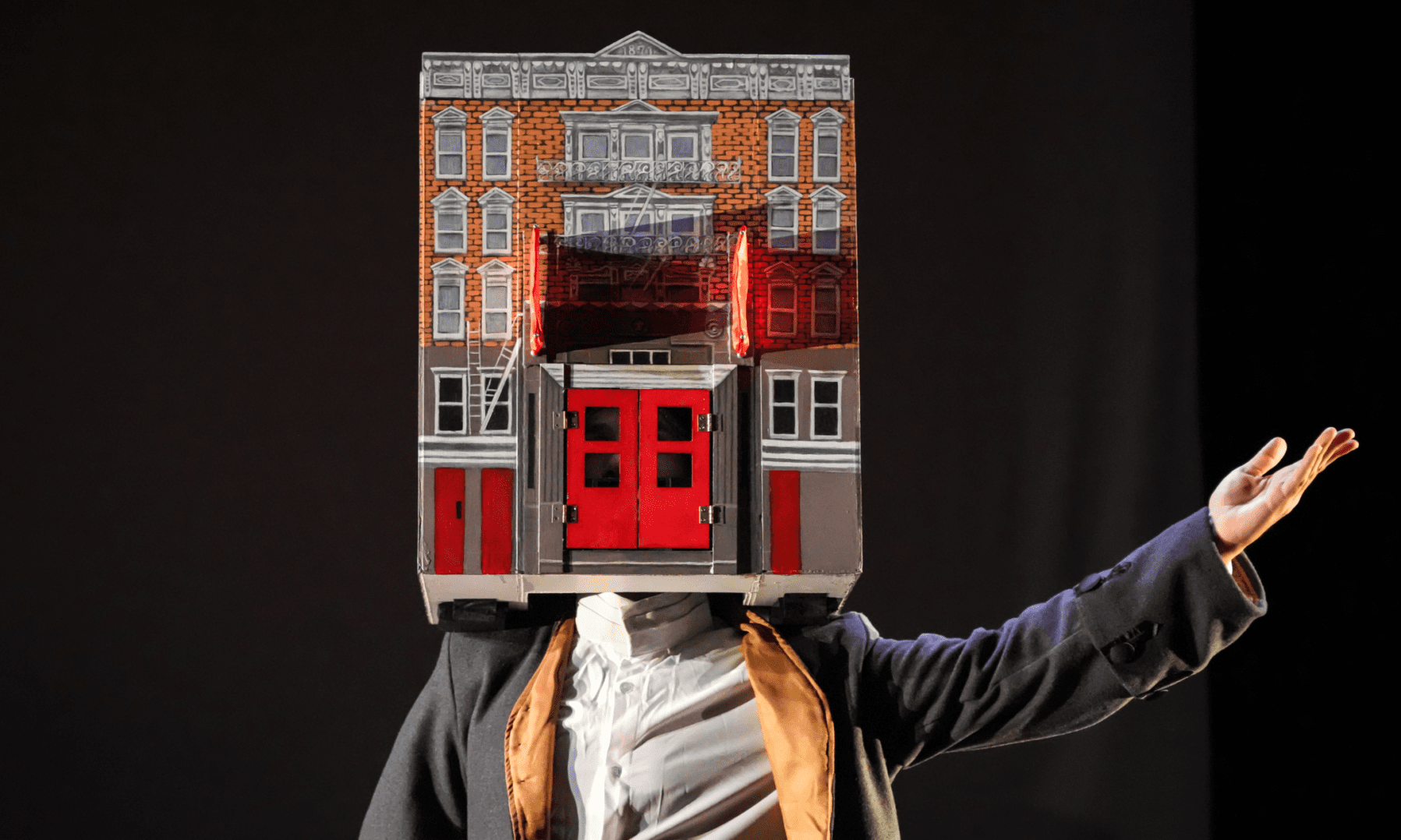 A person wearing a mask with a house on it.