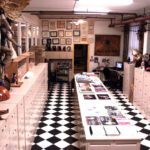 A black and white checkered floor in a room with a lot of items.