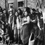 A group of people posing in front of a building.