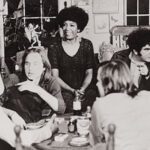 A group of people sitting around a table.