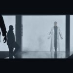 Silhouettes of four people in a studio.