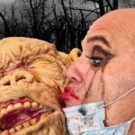 Man kisses grotesque monster face.